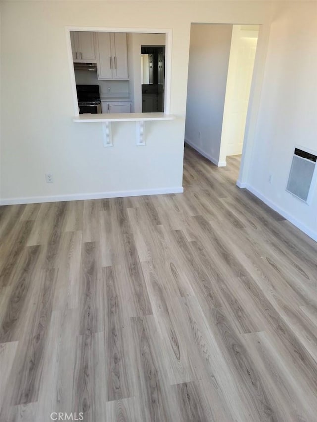 4771 68th St, La Mesa, CA 91942 - kitchen with light wood-style floors, baseboards, range, light countertops, and white cabinetry