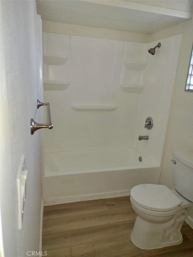 full bathroom featuring  shower combination, wood finished floors, and toilet