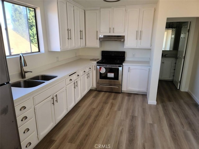 4771 68th St, La Mesa, CA 91942 - kitchen featuring stainless steel electric range, under cabinet range hood, a sink, white cabinetry, and dark wood-style floors