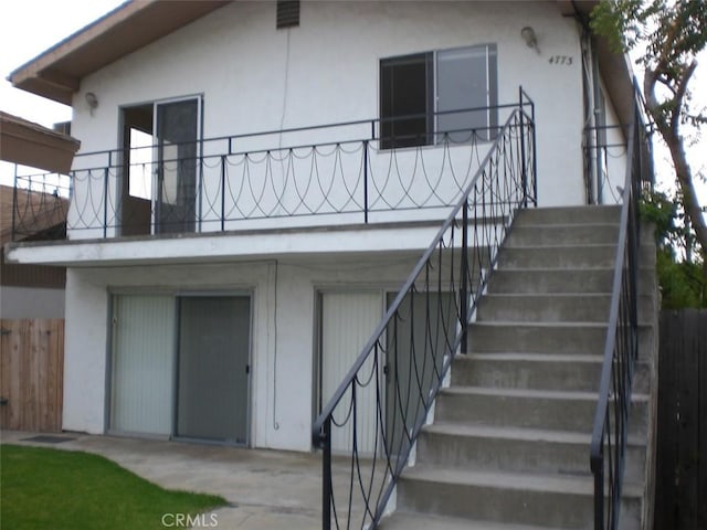 4771 68th St, La Mesa, CA 91942 - back of property with stairs, stucco siding, fence, and a patio area