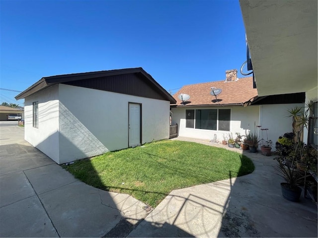 4771 68th St, La Mesa, CA 91942 - rear view of house with a lawn, stucco siding, and a patio area
