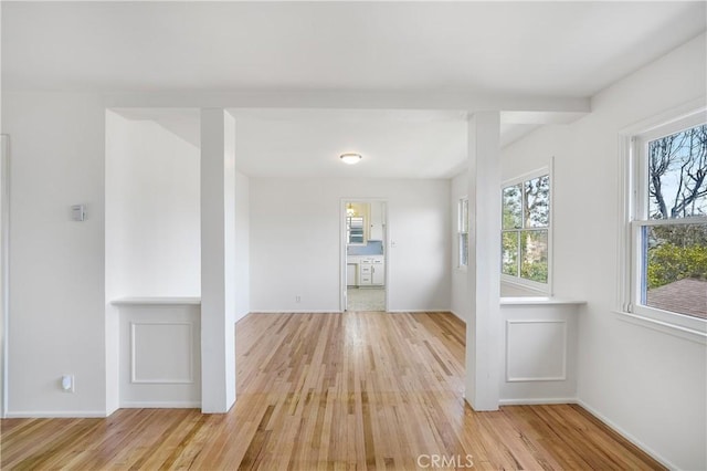 spare room with light wood-type flooring and baseboards