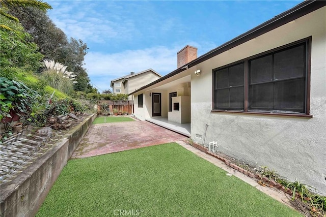 view of yard featuring a patio and fence