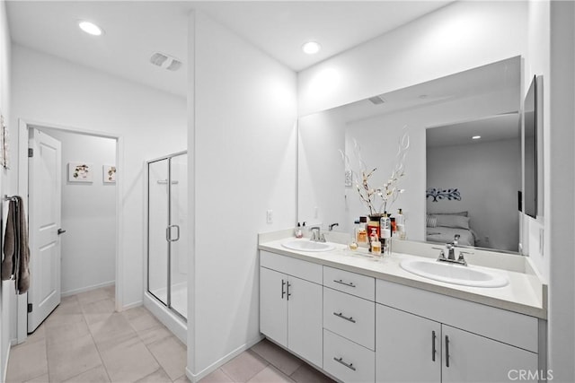 ensuite bathroom featuring a shower stall, double vanity, a sink, and connected bathroom