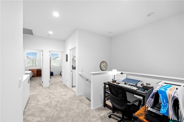 carpeted office space featuring recessed lighting, visible vents, and washing machine and clothes dryer