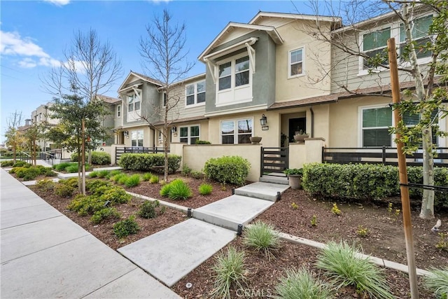 view of property with a fenced front yard and stucco siding