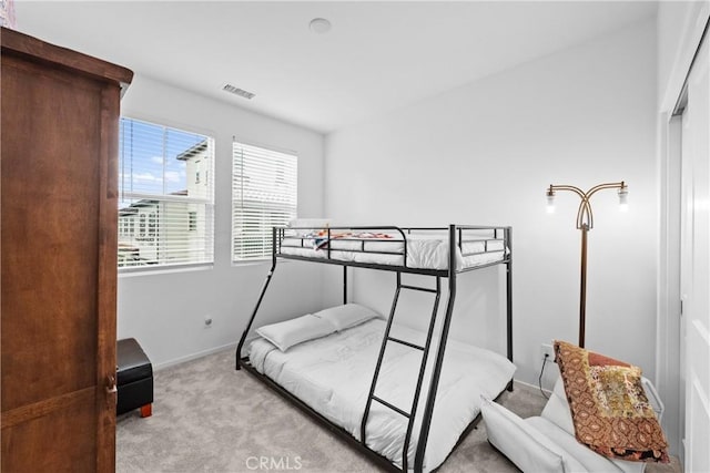 bedroom with carpet, visible vents, and baseboards