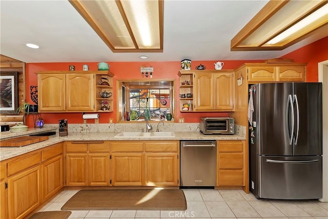 kitchen featuring a toaster, open shelves, stainless steel appliances, a sink, and light stone countertops