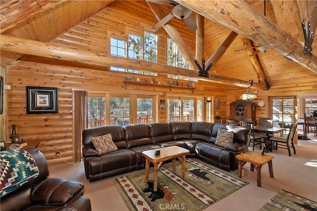 carpeted living room with lofted ceiling with beams, wood ceiling, and log walls