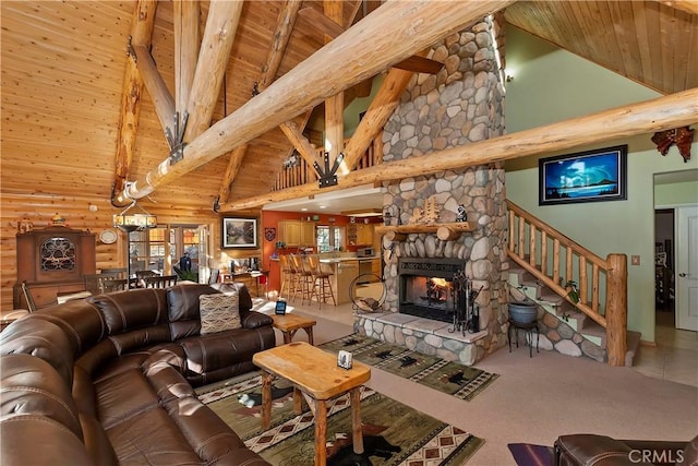 carpeted living area with beam ceiling, a fireplace, stairway, wood ceiling, and high vaulted ceiling