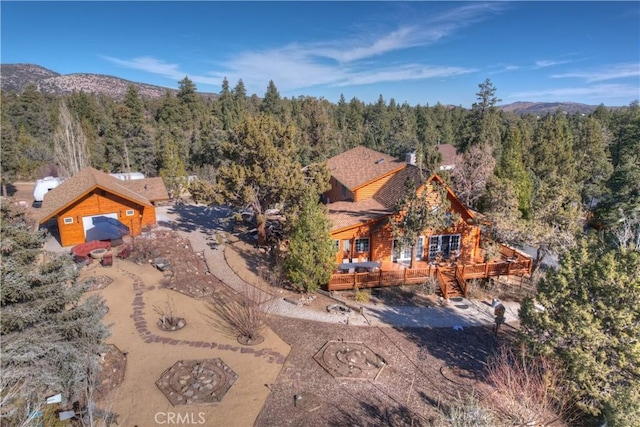 birds eye view of property featuring a wooded view