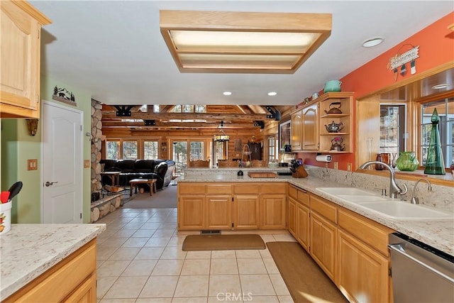 kitchen featuring open shelves, open floor plan, a sink, dishwasher, and a peninsula