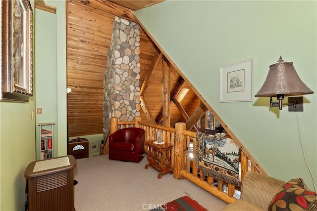 sitting room featuring carpet, wood ceiling, and a high ceiling