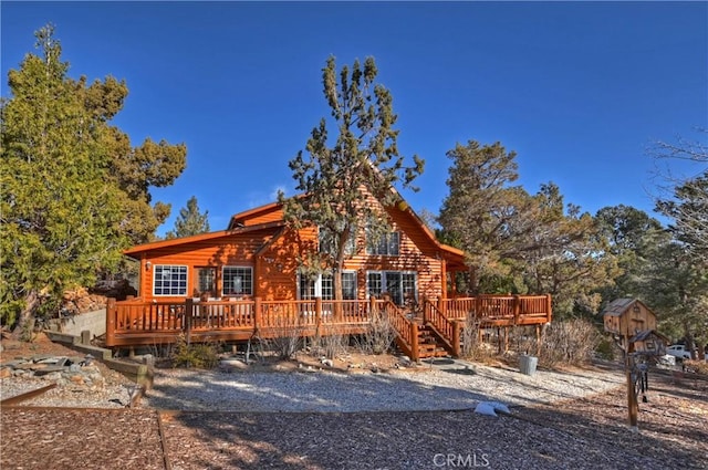 log home featuring a wooden deck