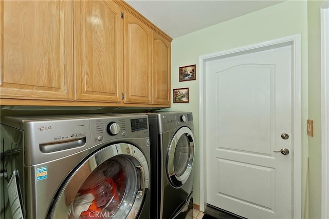 washroom with cabinet space and washer and clothes dryer