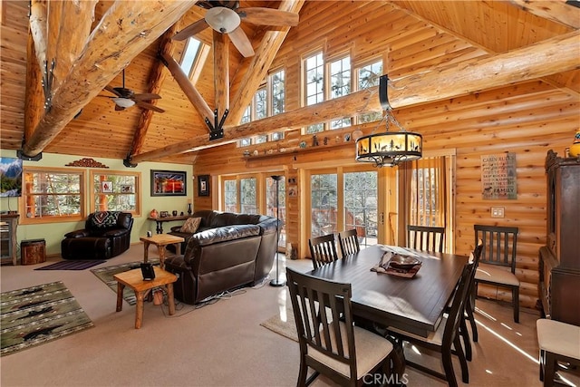 dining area with carpet, beam ceiling, and a healthy amount of sunlight