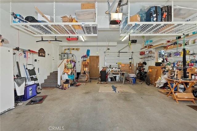 garage with a workshop area and a garage door opener