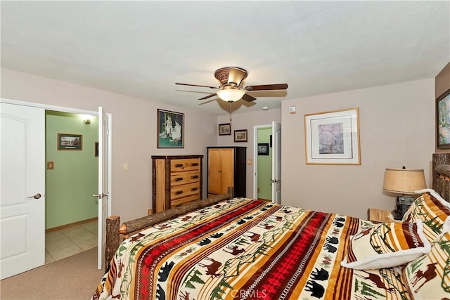 tiled bedroom with a ceiling fan