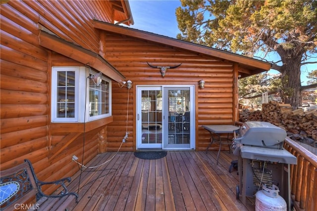 wooden terrace featuring a grill