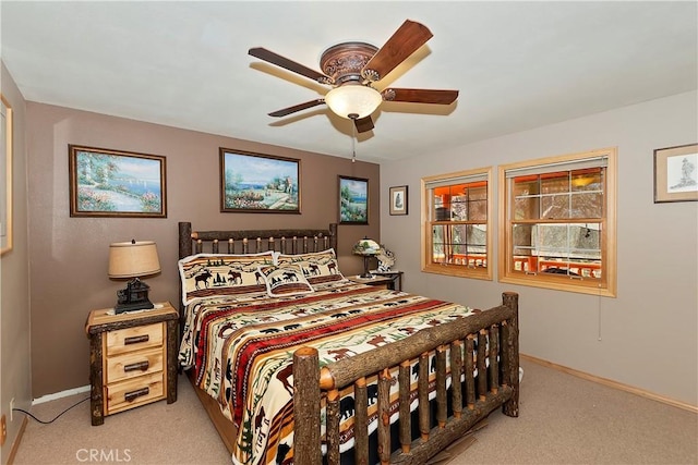 bedroom featuring ceiling fan, baseboards, and light colored carpet