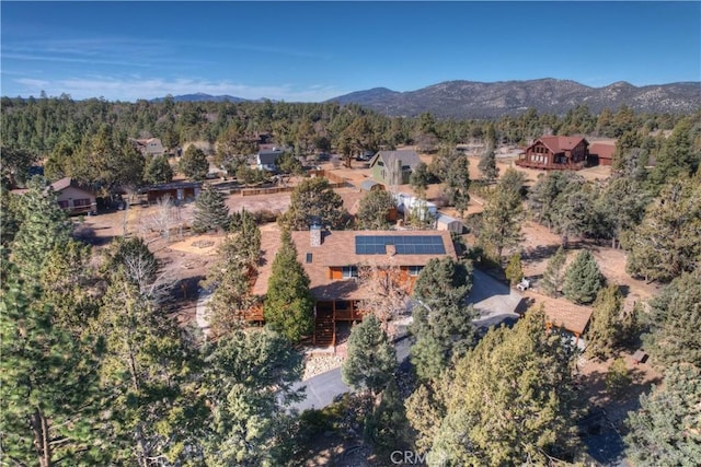 birds eye view of property featuring a mountain view and a forest view