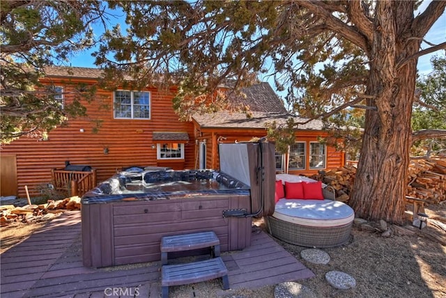 wooden deck with a hot tub