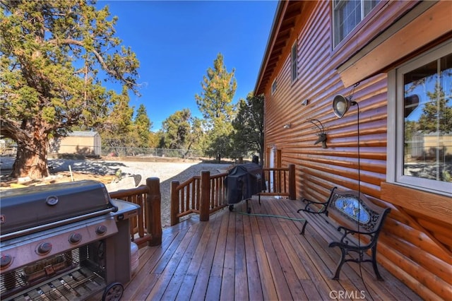 wooden terrace featuring grilling area