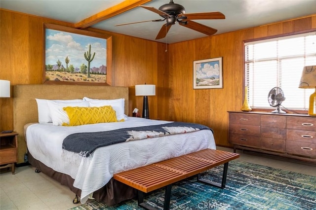 bedroom with light tile patterned floors, ceiling fan, and wooden walls