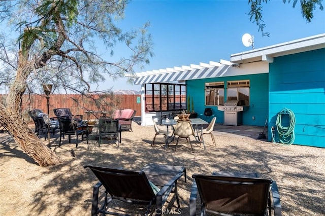 view of patio / terrace featuring outdoor dining area, fence, grilling area, and a pergola