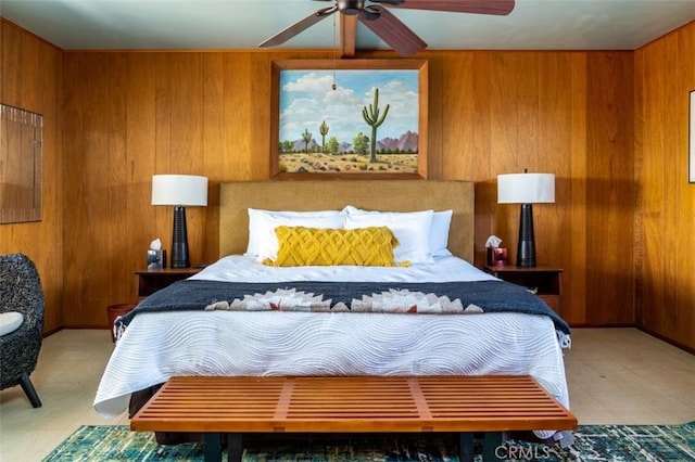 bedroom with ceiling fan and wooden walls