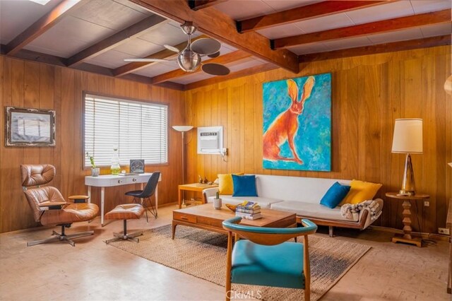 living area featuring ceiling fan, beamed ceiling, an AC wall unit, and wood walls