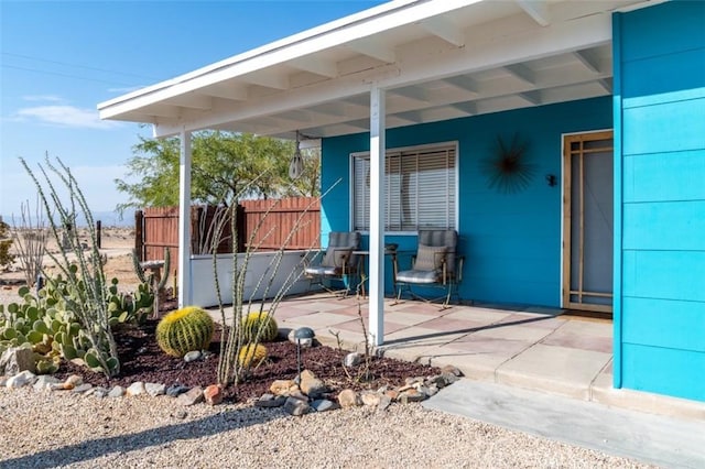 view of patio featuring fence