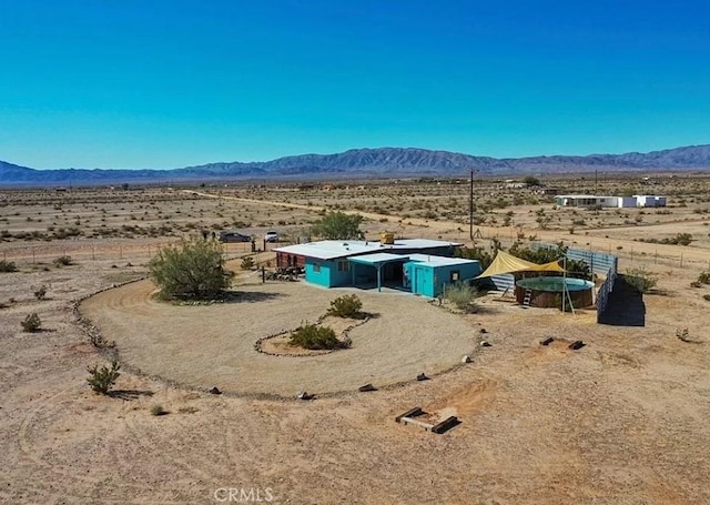 view of yard with a rural view, a desert view, and a mountain view