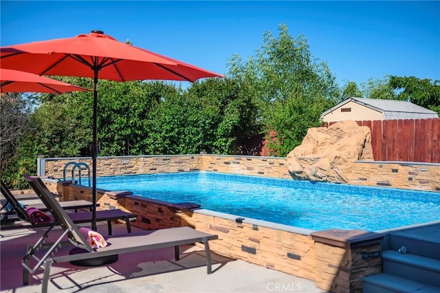 view of swimming pool featuring a patio area, fence, and a fenced in pool