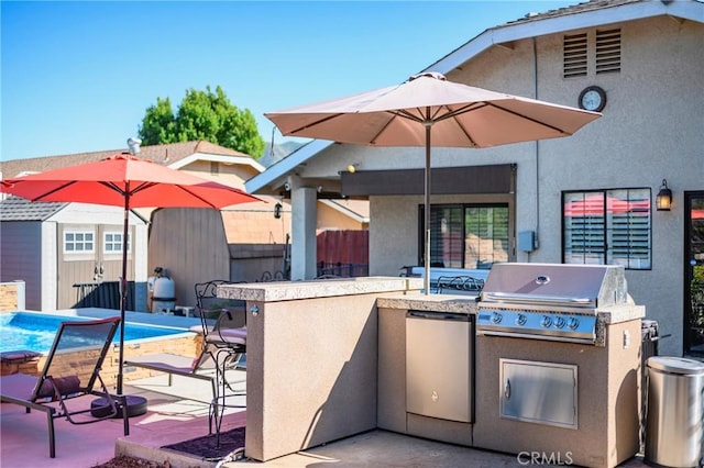 view of patio with grilling area, fence, exterior kitchen, outdoor wet bar, and a pool