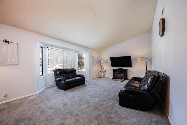 carpeted living room with vaulted ceiling and baseboards