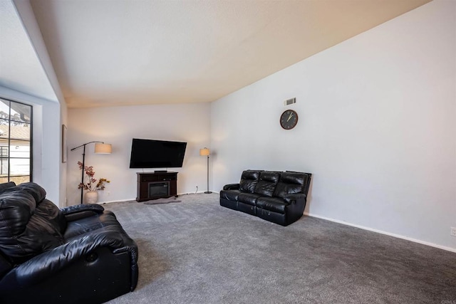 carpeted living area featuring lofted ceiling, visible vents, and baseboards