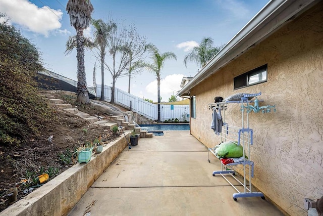 view of patio / terrace featuring fence