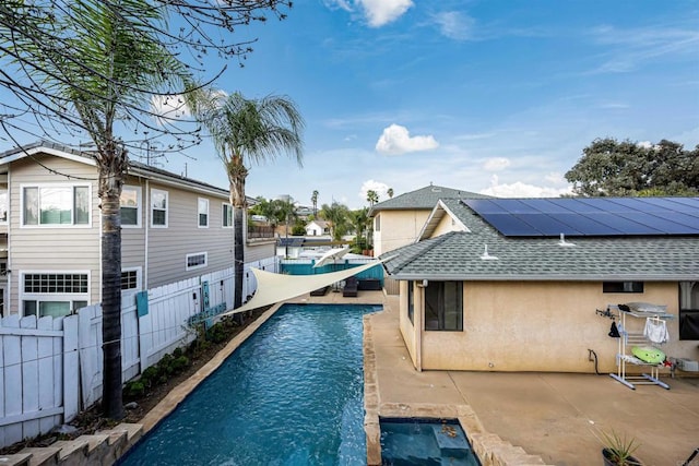 outdoor pool with a fenced backyard and a patio