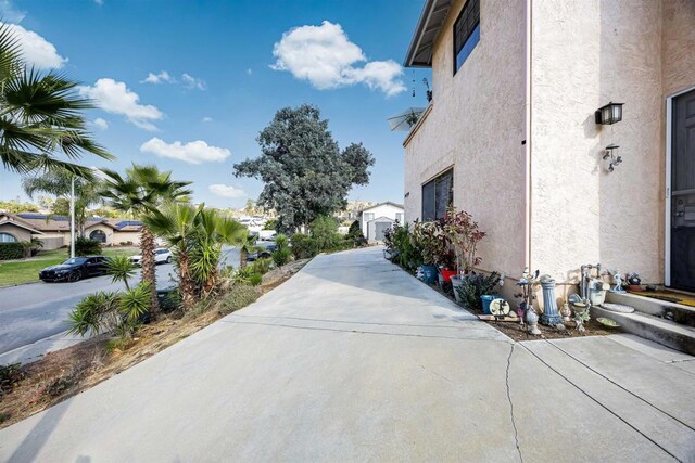 view of road featuring concrete driveway