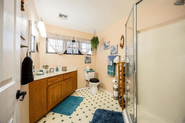 bathroom with a stall shower, baseboards, toilet, tile patterned floors, and vanity