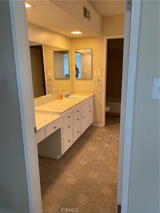 full bath featuring toilet, visible vents, and vanity