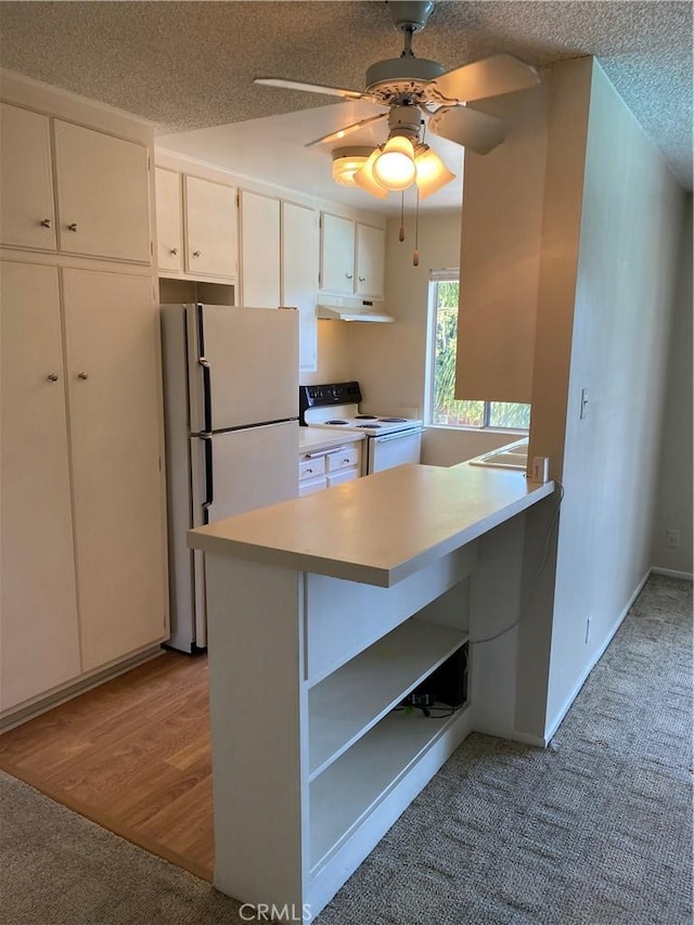 kitchen with white appliances, white cabinets, light countertops, under cabinet range hood, and open shelves