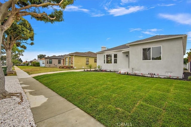 single story home with a front yard and stucco siding