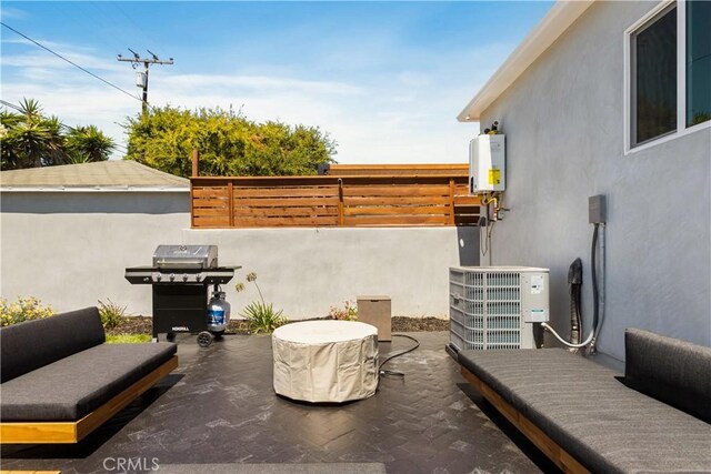 view of patio with cooling unit, grilling area, water heater, and fence