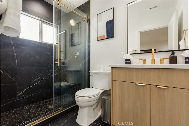 full bath with a marble finish shower, visible vents, toilet, and vanity