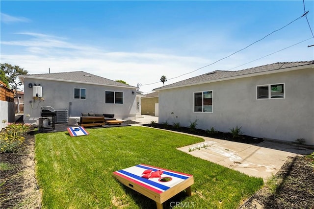 back of house featuring a yard, fence, a patio area, and stucco siding