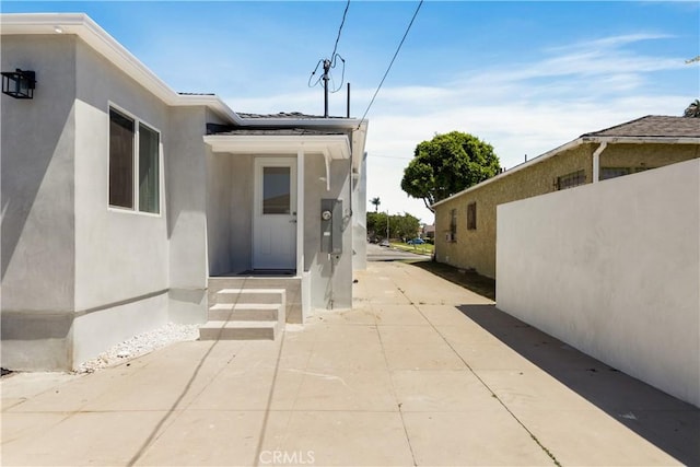 view of exterior entry with stucco siding