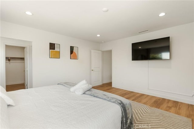 bedroom featuring recessed lighting, wood finished floors, visible vents, and baseboards