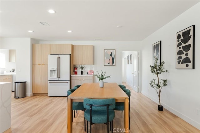 dining room with recessed lighting, light wood-type flooring, and baseboards